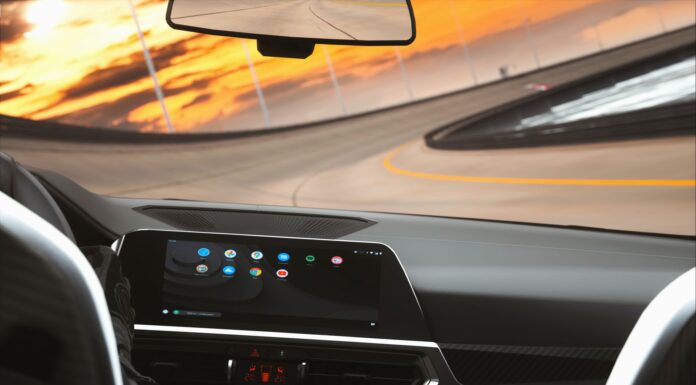 Który system infotainment najmniej rozprasza kierowcę? Test ergonomii i logiki menu Współczesne wnętrze auta z cyfrowym kokpitem podczas jazdy o zmierzchu